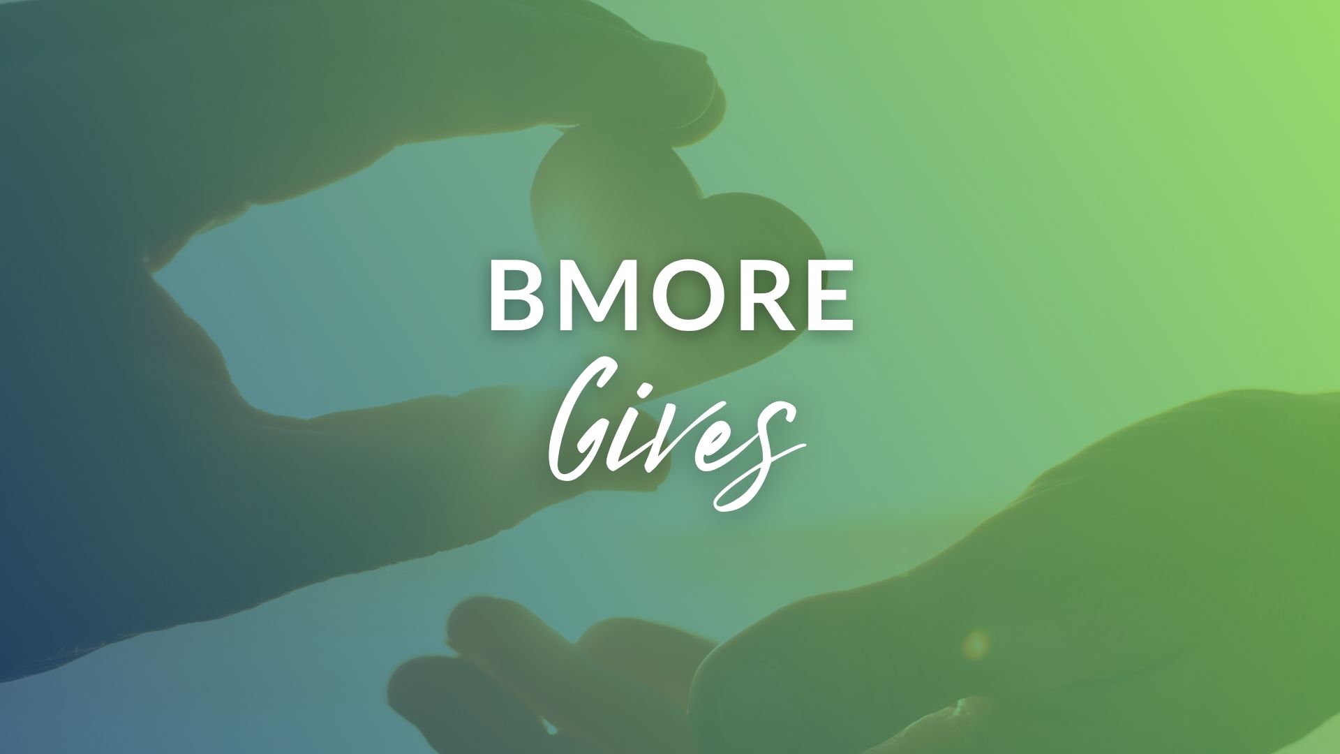 Hands forming a heart shape with the text "B'More Gives" prominently displayed in the center. Background features a gradient of blue and green.